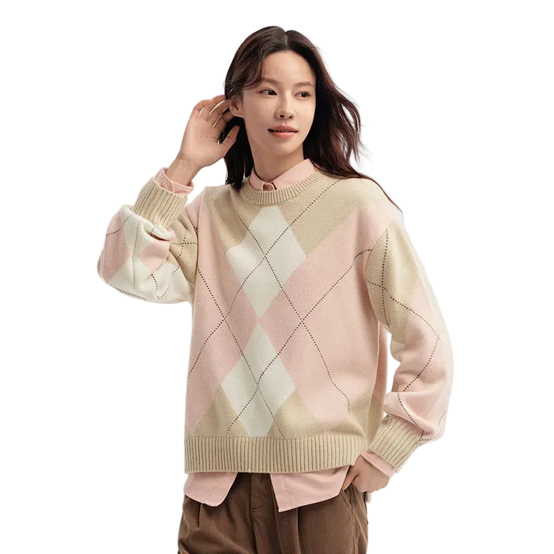 Woman wearing a pastel argyle sweater on a light background