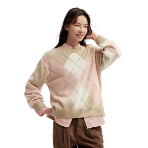 Woman wearing a patterned sweater on a plain background