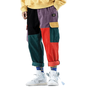 Colorful patchwork pants worn by a person on a plain background