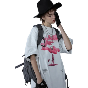 Person wearing a white t-shirt with a graphic design, black hat, and gray backpack against a plain background