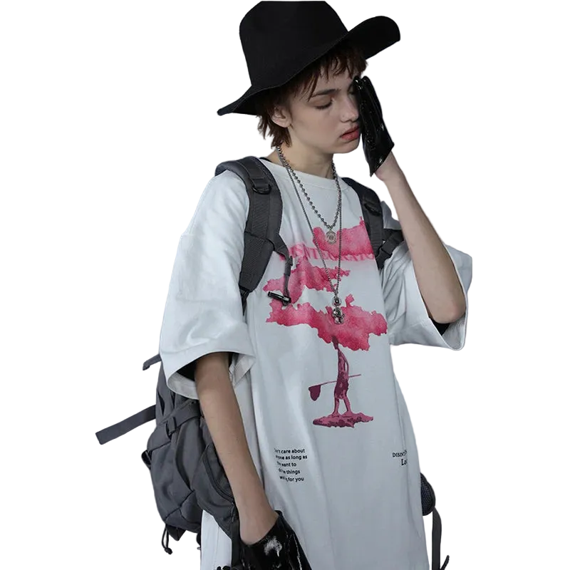Person wearing a white t-shirt with a graphic design, black hat, and gray backpack against a plain background