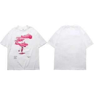 White t-shirt with a graphic design of a person holding a pink cloud and a mushroom cloud on a white background.