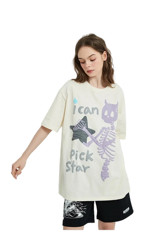 Person wearing a cream-colored t-shirt with a graphic design and black shorts on a white background