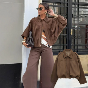 Effortlessly chic and oversized black bomber jacket with sophisticated collar and epaulet details.