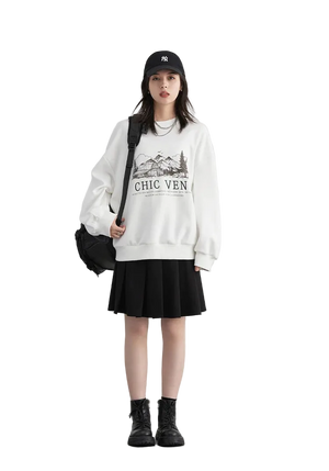Person wearing a white sweatshirt with text and graphics, black skirt, and black boots on a plain background