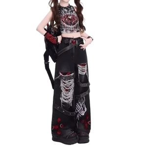Person wearing a black, red, and white outfit with distressed jeans on a white background