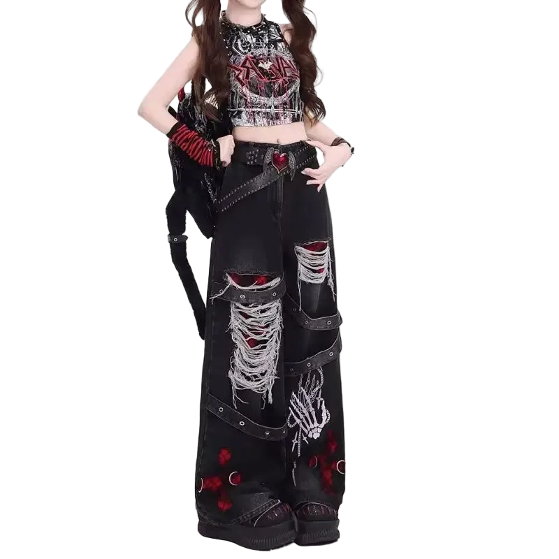Person wearing a black, red, and white outfit with distressed jeans on a white background
