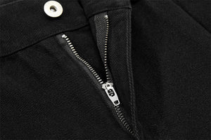Close-up of a black jacket with a zipper and button detail