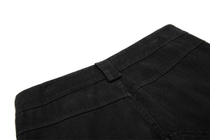 Close-up of a black fabric with a pocket detail on a white background