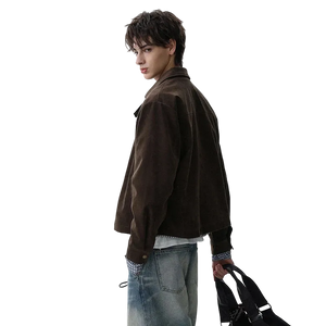 Person wearing a brown jacket and blue jeans holding a black bag on a white background
