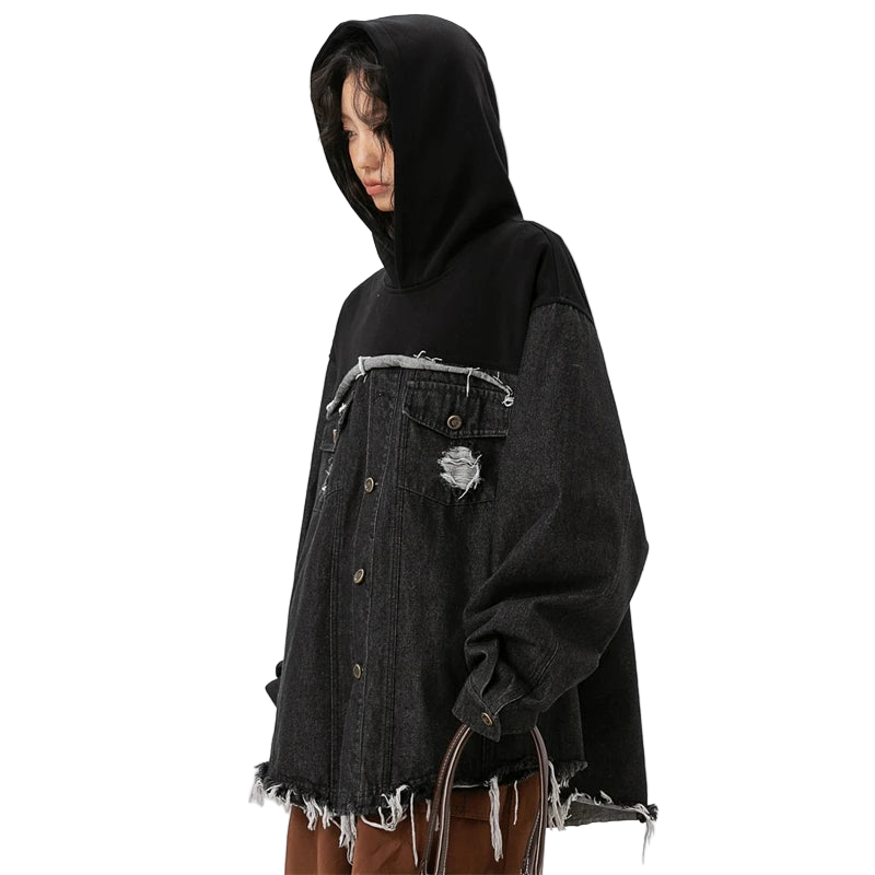 Person wearing a black hoodie and distressed denim jacket on a white background