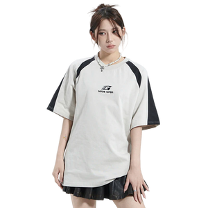 Person wearing a white and black sports outfit with a brand logo on a white background