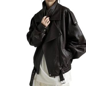 Person wearing a dark leather jacket on a plain background