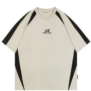 Beige t-shirt with black accents and a brand logo on a white background