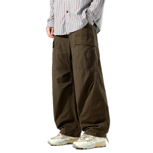 Person wearing brown cargo pants and a striped shirt on a white background