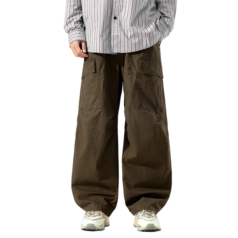 Person wearing brown cargo pants and a striped shirt on a white background