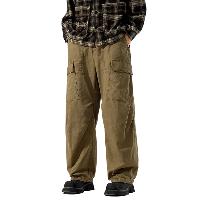 Person wearing brown cargo pants and a plaid shirt on a white background