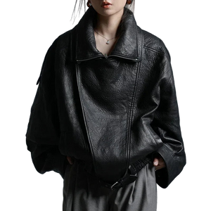 Person wearing a black leather jacket against a gray background