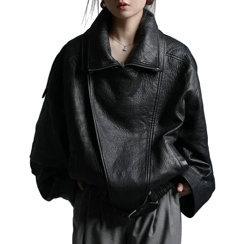 Person wearing a black leather jacket against a gray background