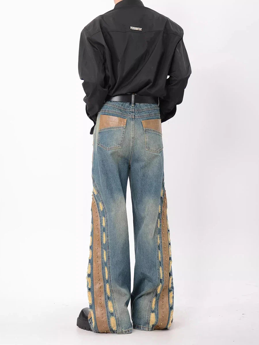 Jean vintage en patchwork de cuir clouté et usé