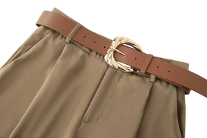 Brown pants with a brown belt and gold buckle on a white background
