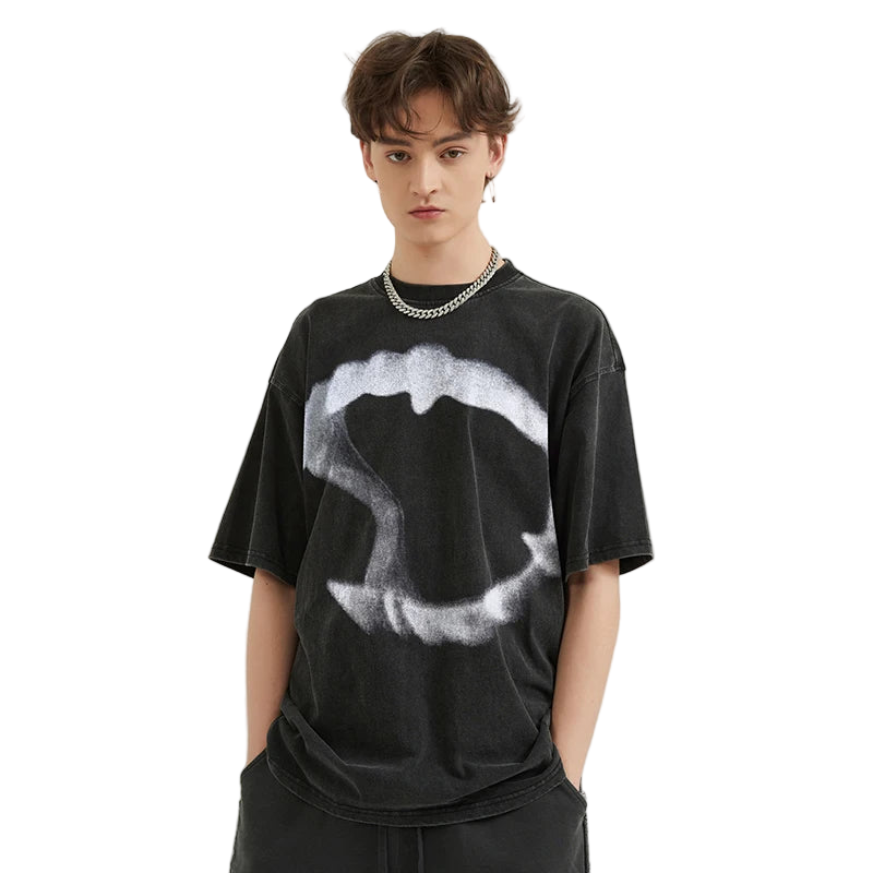 Person wearing a black t-shirt with a white graphic design on a plain background