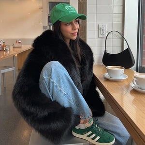 Style yourself in this luxurious black faux fur jacket, designed with an ultra-plush texture and voluminous collar for the ultimate glamorous streetwear statement.