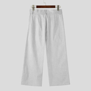 Light gray pants on a hanger against a white background