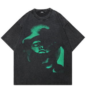 Black t-shirt with green graphic design on a white background