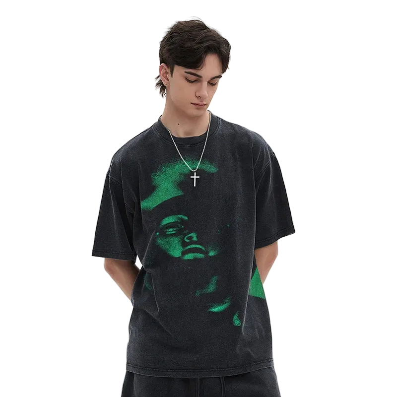 Person wearing a black t-shirt with a green graphic design on a white background