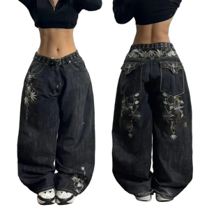 Black wide-leg jeans with floral embroidery on a plain background