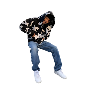 Person wearing a star-patterned hoodie and blue jeans on a white background