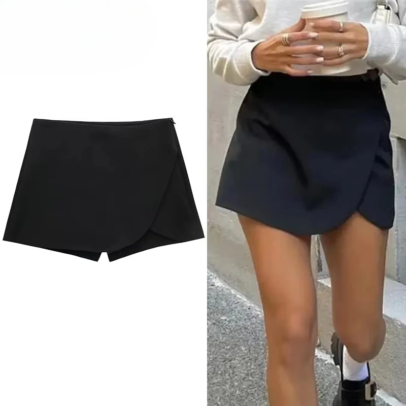 Black mini skirt shown on a plain background and worn by a person outdoors.