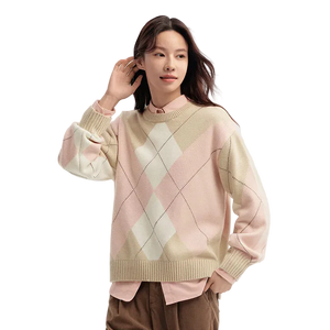 Woman wearing a pastel argyle sweater on a light background