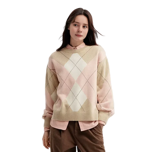 Woman wearing a pastel argyle sweater on a light background