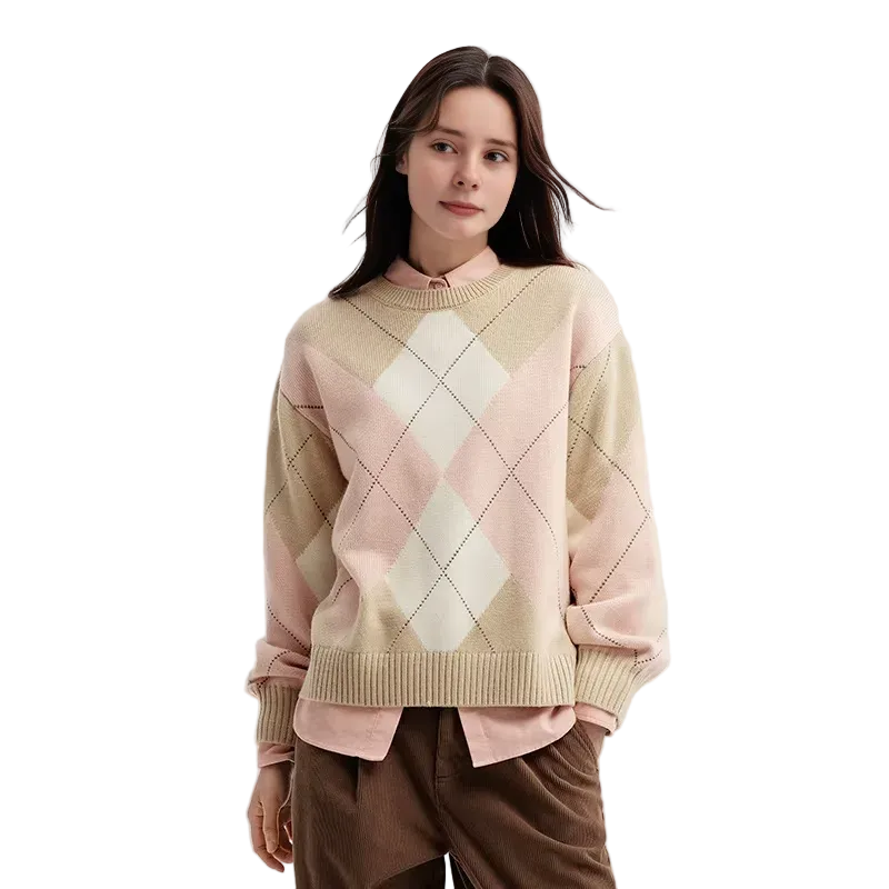 Woman wearing a pastel argyle sweater on a light background