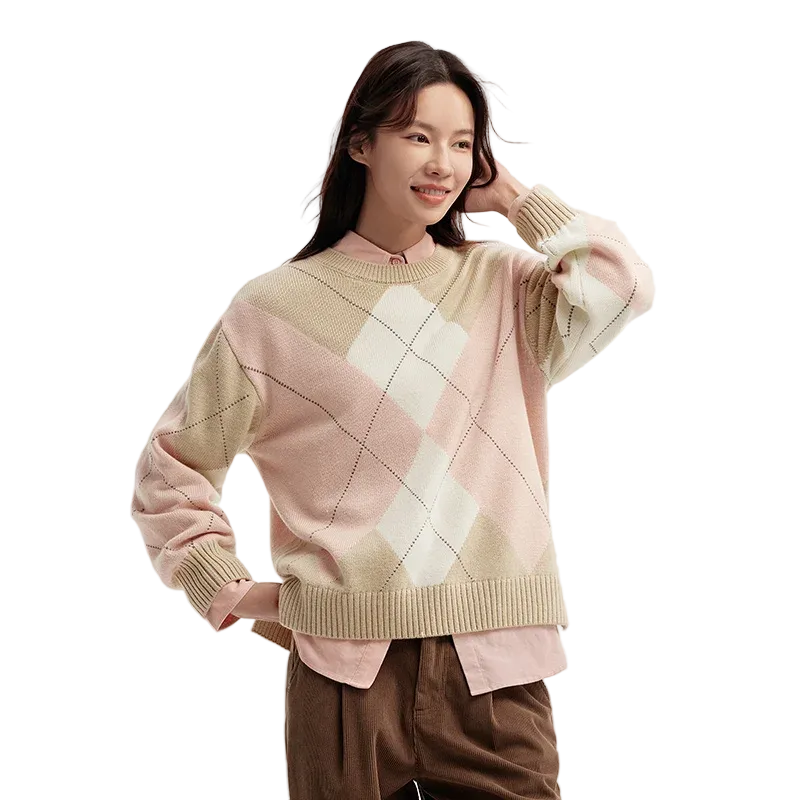 Woman wearing a patterned sweater on a plain background