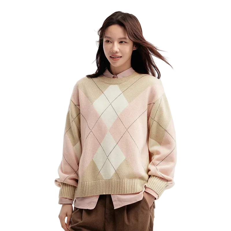 Woman wearing a pastel argyle sweater on a light background