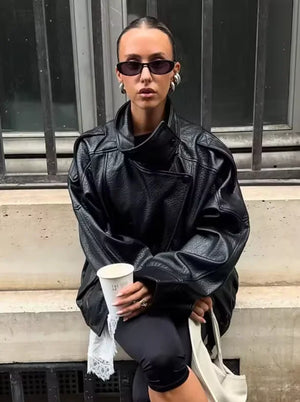 Style yourself in this oversized black leather jacket, featuring a chic high collar and elasticated hem for a sophisticated yet edgy streetwear look.