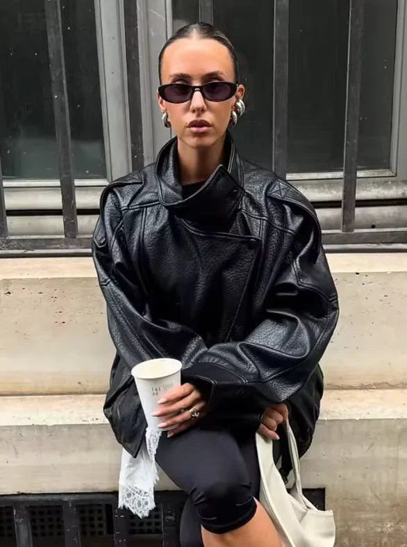 Style yourself in this oversized black leather jacket, featuring a chic high collar and elasticated hem for a sophisticated yet edgy streetwear look.