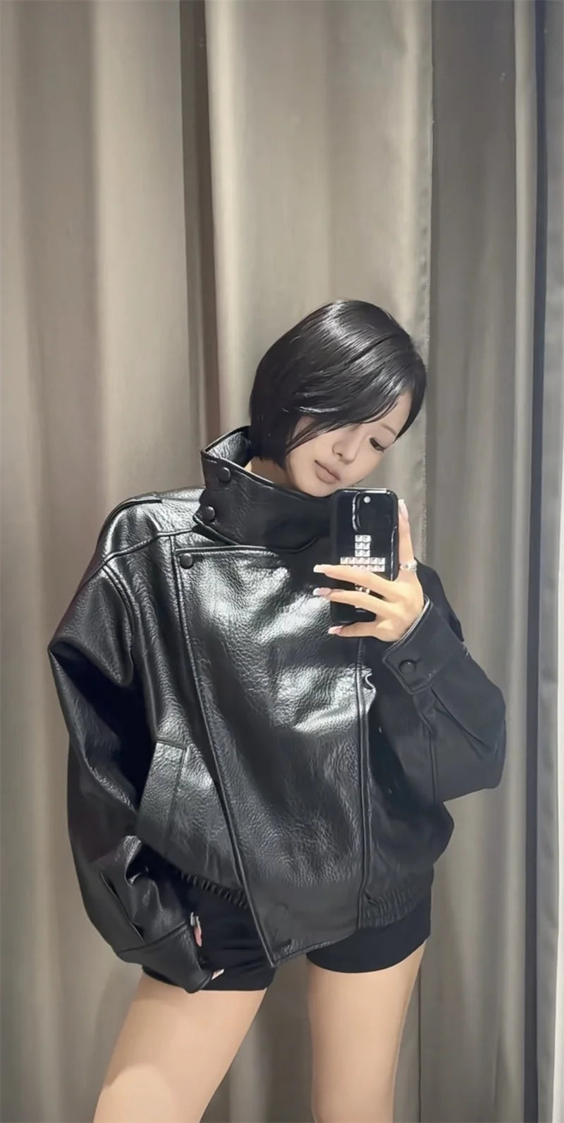 Style yourself in this oversized black leather jacket, featuring a chic high collar and elasticated hem for a sophisticated yet edgy streetwear look.