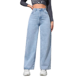 Person wearing light blue jeans against a gray wall