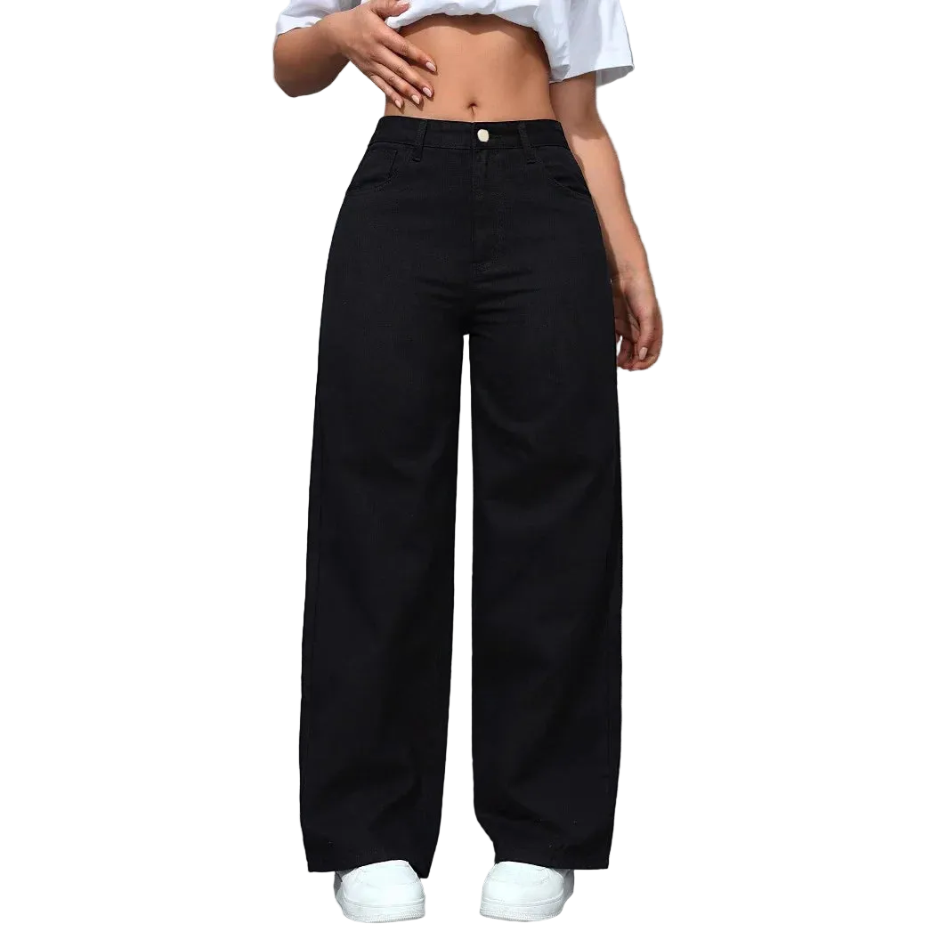 Person wearing black wide-leg pants and a white crop top against a gray wall.