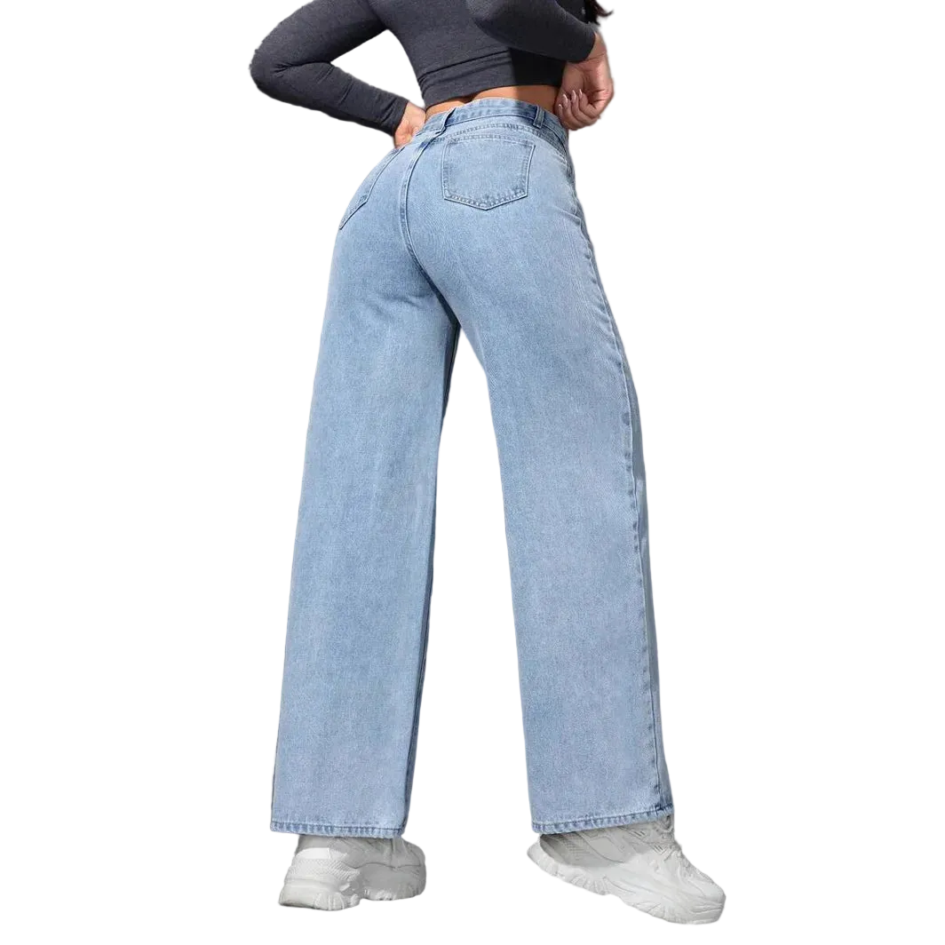 Person wearing light blue jeans and white sneakers against a gray wall