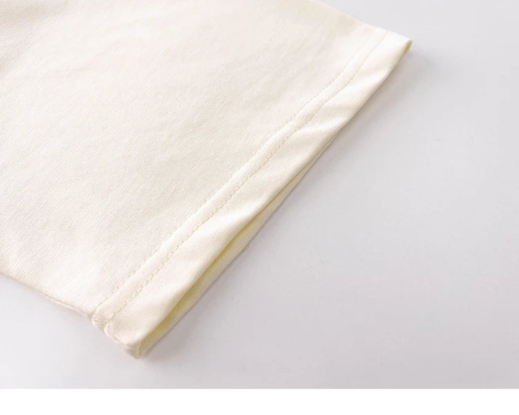 White fabric folded on a light gray surface