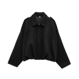 Effortlessly chic and oversized black bomber jacket with sophisticated collar and epaulet details.
