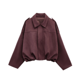 Effortlessly chic and oversized black bomber jacket with sophisticated collar and epaulet details.