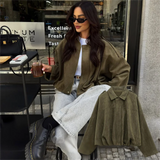 Effortlessly chic and oversized black bomber jacket with sophisticated collar and epaulet details.