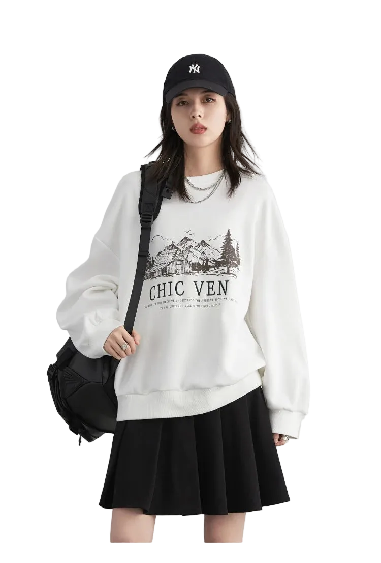 Person wearing a white sweatshirt with a graphic design and text, black skirt, and black cap on a light gray background