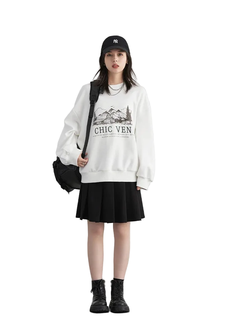 Person wearing a white sweatshirt with text and graphics, black skirt, and black boots on a plain background